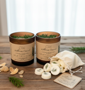 Wilderness Covenant candles with natural elements on a wooden surface